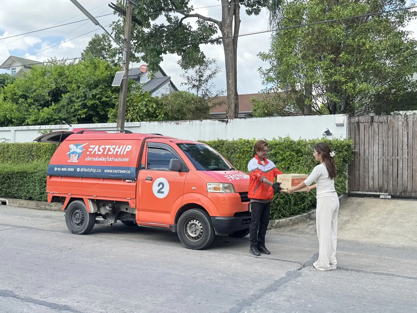 A FastShip van handing over a parcel